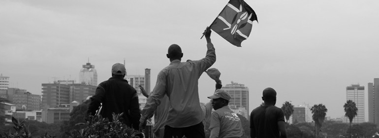 A supporter waves a Kenyan flag at the rally.