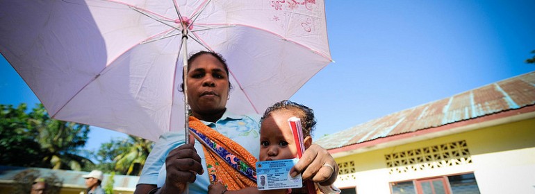 A woman shows her voter registration card at a polling station in Timor-Leste, where she is waiting to cast her vote in today’s presidential run-off.