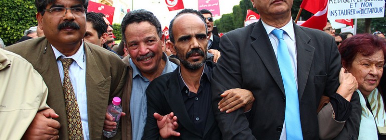 Brahmi at a protest, on the far left